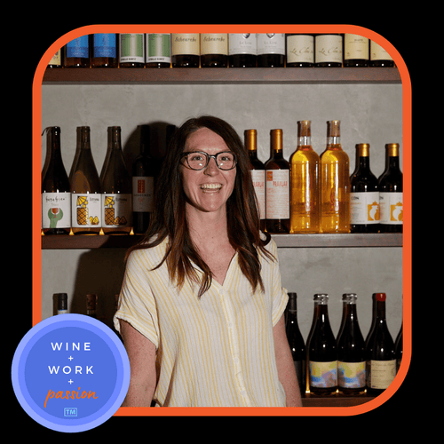 Napa Valley Wine Academy Wine Articles and Podcasts a woman smiling at the camera, standing in front of shelves filled with wine bottles, with a close-up of a bottle beside her.