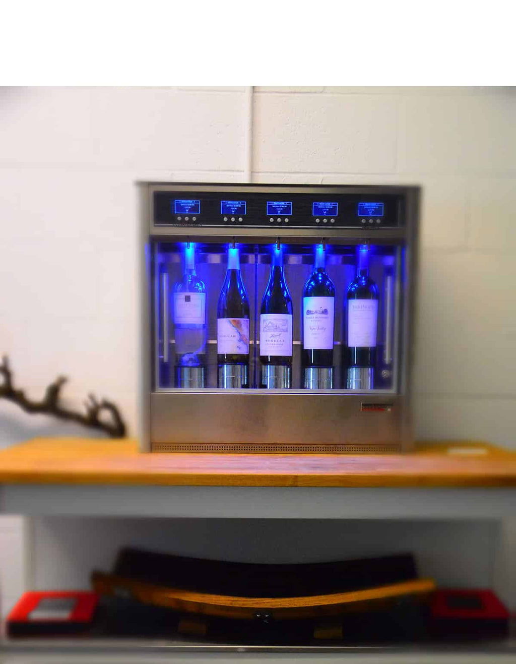 A wine cooler filled with bottles of wine, showcasing a close-up view of several bottle labels.