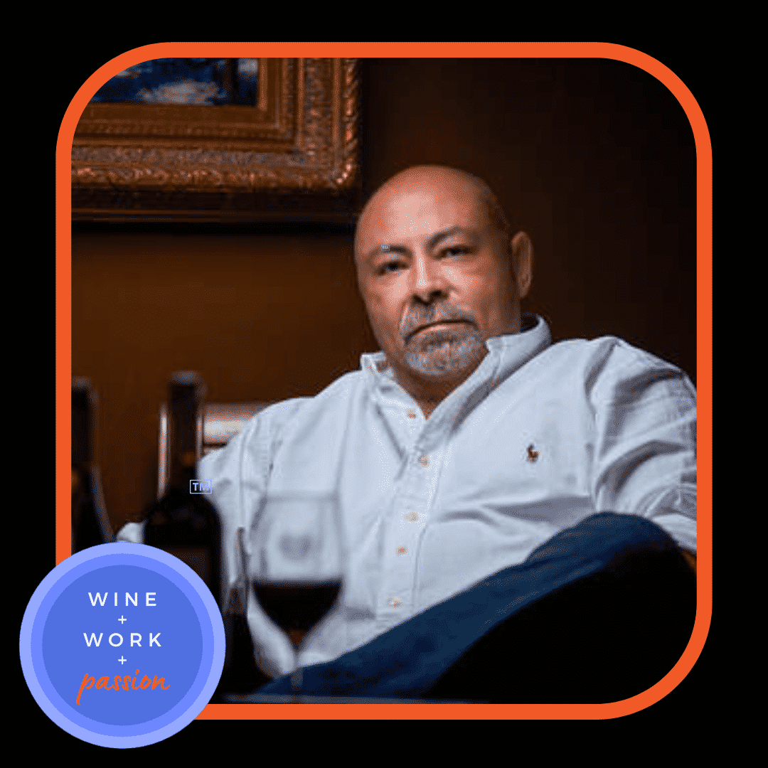 Napa Valley Wine Academy Wine Articles  A man with a beard sits in a chair holding a glass of wine, with a close-up of his face and shirt visible.