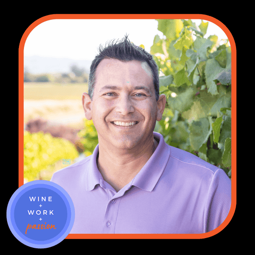 Napa Valley Wine Academy Wine Articles  A close-up of a smiling man wearing a shirt, with a blue circle and white text in the background.