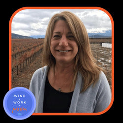 Napa Valley Wine Academy Wine Articles  A woman smiling at the camera, showing her face and neck, with a blue circle containing white text partially visible in the background.