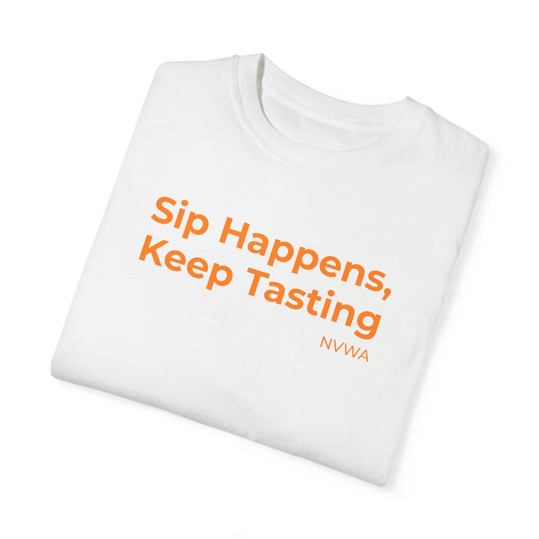 NVWA T-shirt “Sip Happens, Keep Tasting” with orange text on white fabric, showcasing a relaxed fit and crew neckline for casual wear.