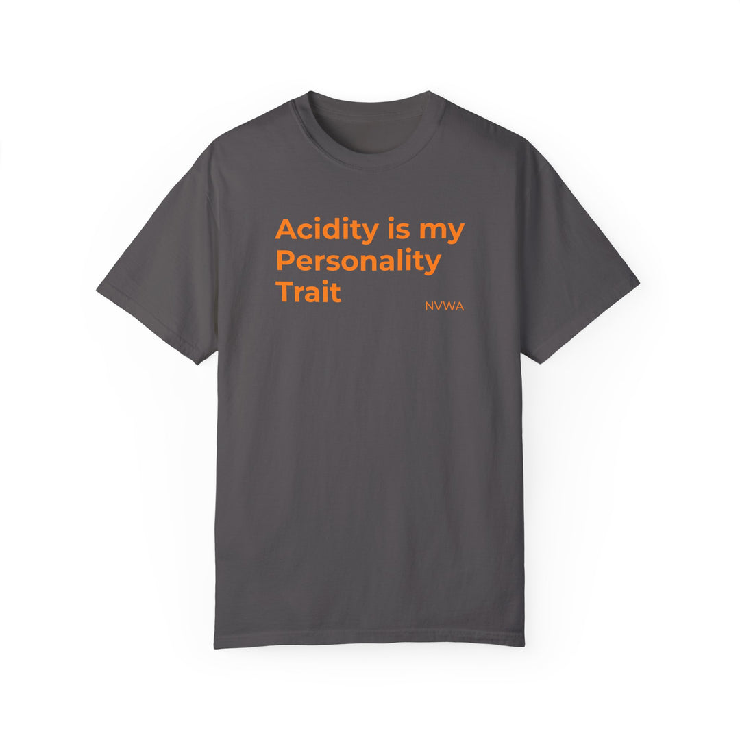 NVWA T-shirt “Acidity is my Personality Trait” features orange text on a grey background, ideal for wine enthusiasts, available in various sizes.