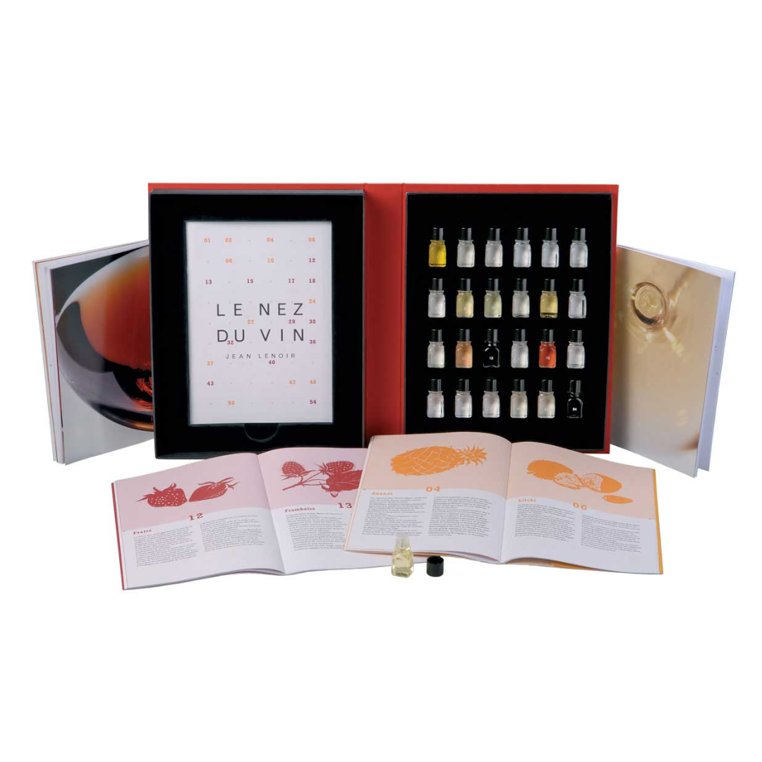 24 Aroma – Duo Kit | Le Nez du Vin: An open book and small bottles of liquid, part of a wine aroma identification kit with accompanying manuals.