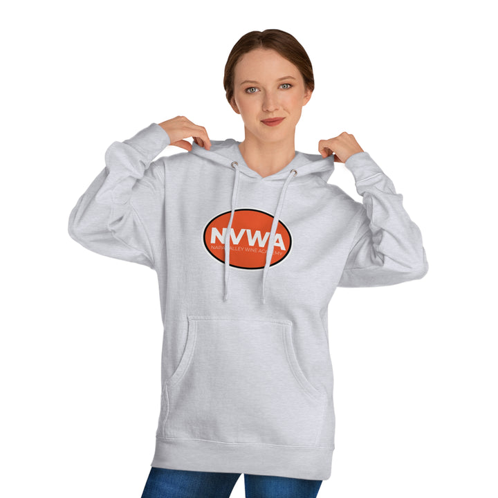 Woman wearing NVWA Emblem Unisex Hooded Sweatshirt, showcasing the logo. She adjusts the hood, highlighting the comfortable, casual design with ribbed cuffs and drawstrings.