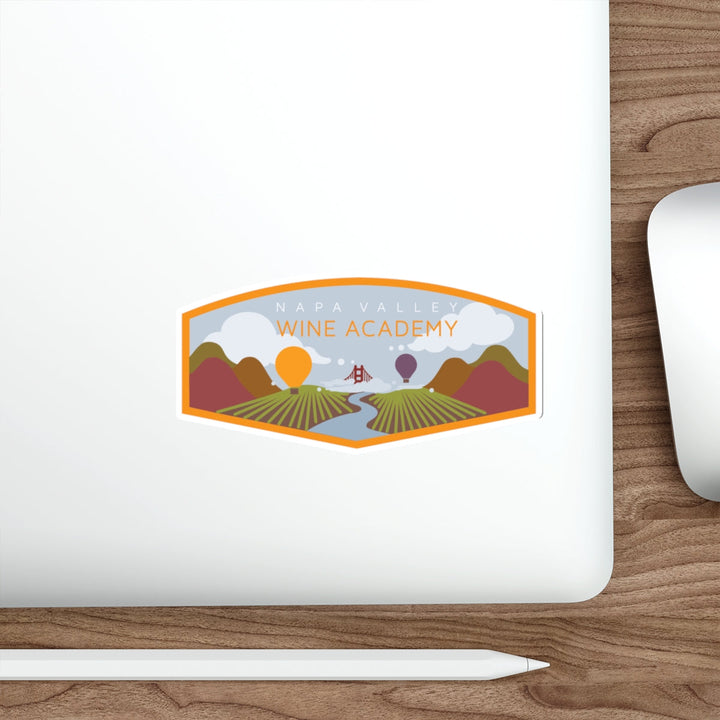 Napa Valley Wine Academy Landscape Stickers on a laptop with a pen, showcasing vineyards, hills, hot air balloons, and the Golden Gate Bridge.