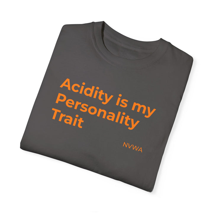 Grey NVWA T-shirt showcasing the bold orange text “Acidity is my Personality Trait,” offering a quirky vibe for wine enthusiasts. Ideal for casual or dressed-up occasions.