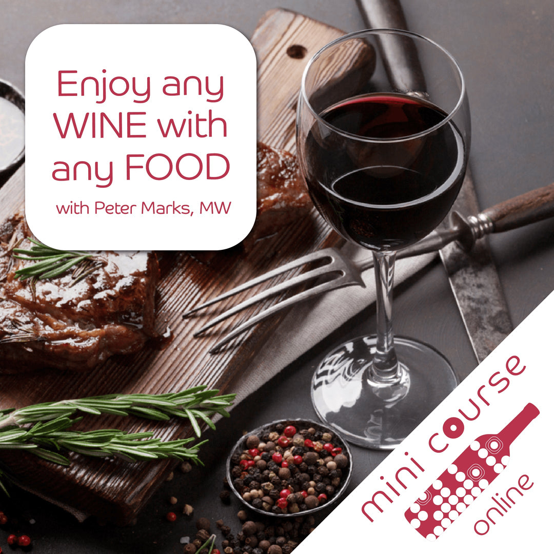 A glass of wine on a table next to a knife and fork, representing the Enjoy Any Wine with Any Food online course.