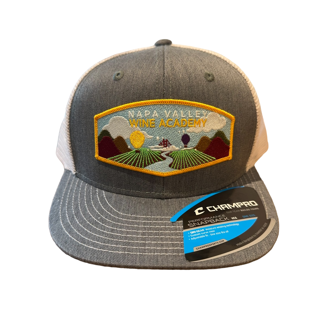 NVWA Baseball Cap with NVWA Patch featuring a vineyard image, showcasing a detailed label on the front. Ideal for wine enthusiasts and professionals.