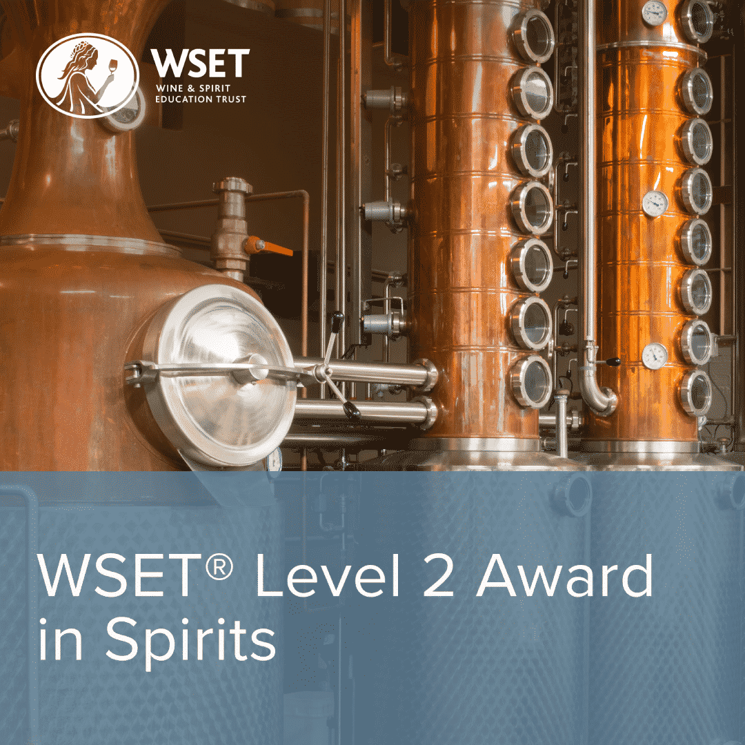 Close-up of WSET Level 2 Spirits Online Course materials, including a machine and metal cylinder, illustrating the hands-on learning experience for spirits and liqueurs.