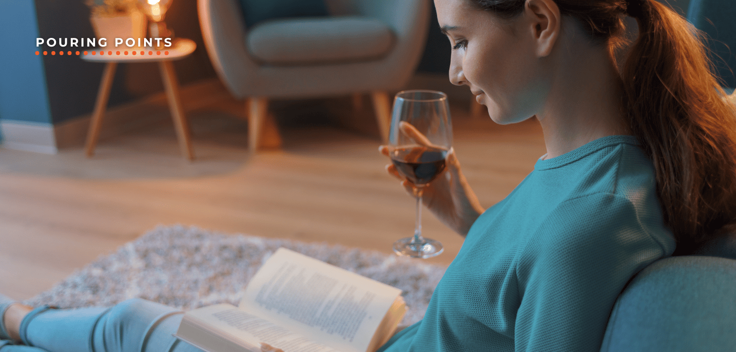 Woman drinking wine and reading