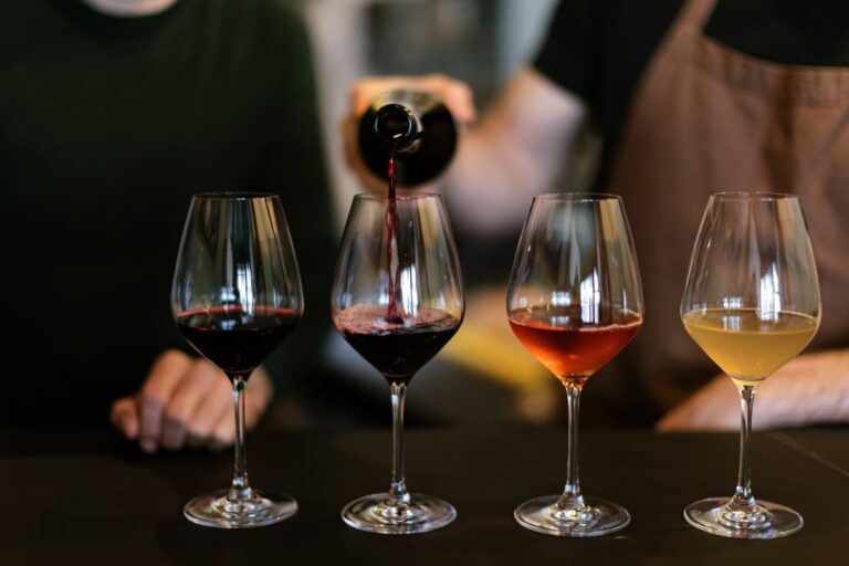 wine glasses on bar top with 4 kinds of wine